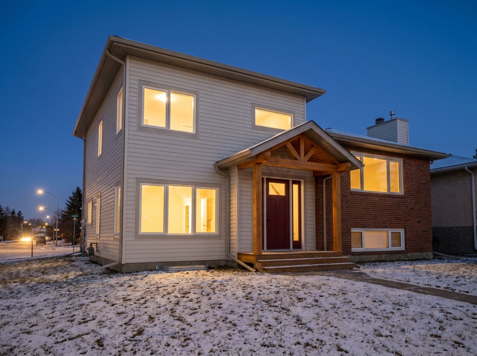 Completed two-storey home addition at dusk on a Red Deer street